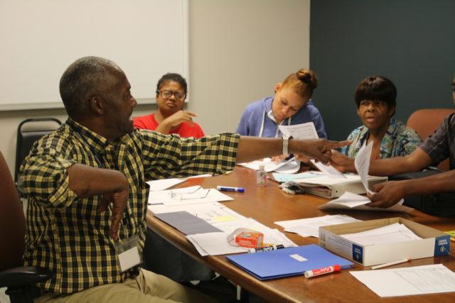 John Lewis teaches a math class for Deaf Consumers